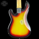 The back of a classic electric guitar with a sunburst finish transitioning from yellow to red and black, set against a solid black background.