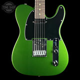 A green metallic electric guitar with a black pickguard and chrome hardware, shown against a solid black background with a Tone Shop watermark in the top left corner.