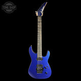 A blue electric guitar with a metallic blue finish, black hardware, and a dark fretboard, shown against a solid black background. A Tone Shop watermark is visible in the top-left corner.