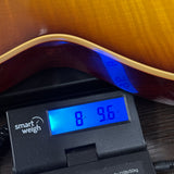 Gibson Custom Dealer Select 1959 Les Paul Standard Tejas Burst AAA Top VOS on scale displaying weight.