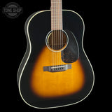 Acoustic guitar with a sunburst finish on a black background, featuring the Tone Shop logo.