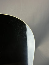Close-up of a black surface with visible scratches on a gray background