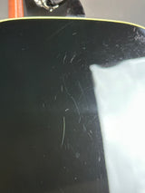 Close-up of a black surface with scratches and a white area.