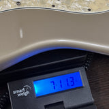 Used 1997 Fender US Roadhouse Stratocaster Shoreline Gold on scale displaying weight.