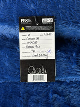 PRS guitar packaging on a blue textured surface