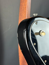 Close-up of a guitar's headstock with tuning pegs