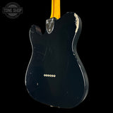 Black electric guitar body with visible brand logo on a black background