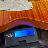Used 1995 Fender Foto Flame Telecaster MIJ Autumn Burst on scale displaying weight.
