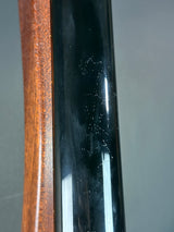 Close-up of a black and wooden object with a reflective surface