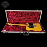 Yellow electric guitar in a red-lined case with 'Tone Shop' logo.