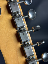 Close-up of guitar tuning pegs on a wooden neck