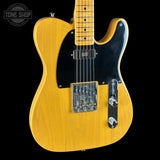 Yellow electric guitar with a black pickguard on a black background, featuring 'Tone Shop' logo.