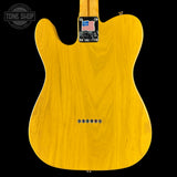 Yellow electric guitar body with a visible brand logo on a black background