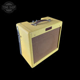A vintage-style Fender amplifier with a textured cream-yellow fabric cover, brown front grille, and silver handle, shown on a solid black background with a Tone Shop watermark in the top-left corner.