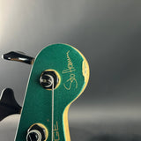 Close-up of a green guitar headstock with 'Stehlen' branding on a gray background