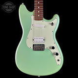 A mint green electric guitar with a white pickguard and silver hardware, shown against a solid black background. A Tone Shop watermark is visible in the top-left corner.