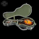 Mandolin in a green case with 'Tone Shop' logo in the corner.