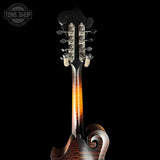 Close-up of a mandolin with a dark background and 'Tone Shop' logo.
