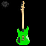 Green electric guitar with a black background
