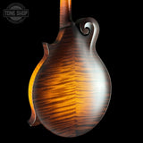 Close-up of a wooden mandolin on a black background with 'Tone Shop' logo.