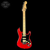 Red electric guitar with a black background