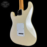 The back of a Fender Stratocaster electric guitar in a cream/off-white finish, featuring a white pickguard and maple neck, shown against a solid black background.