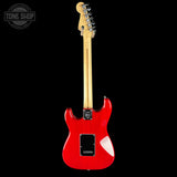 Red electric guitar with a black background