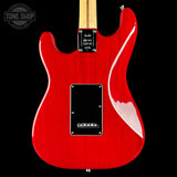 Red electric guitar with a visible brand logo on a black background