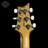 Guitar headstock with 'Wood Library' branding on a black background