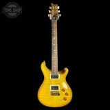 Yellow electric guitar on a black background with 'Tone Shop' logo.