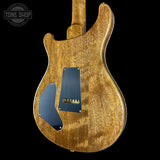 Back view of a wooden electric guitar with a visible brand logo in the corner.