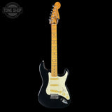 Electric guitar with a black body and blonde neck on a white background, featuring 'Tone Shop' branding.