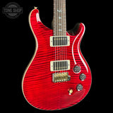 Red electric guitar with a black background