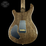 back of electric guitar with a stained brown finish on a black background.