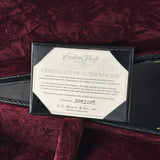 Certificate of authenticity on a guitar case with a maroon background