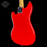 Red electric guitar body with Fender logo on a black background