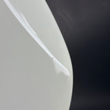 Close-up of a white ceramic plate with a black background