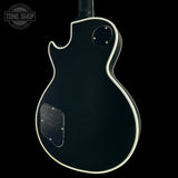 Black electric guitar body with a visible brand logo in the corner.