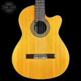 Acoustic guitar with a visible brand logo on a black background