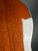 Close-up of a wooden object with a white edge on a dark background