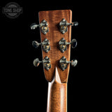 Close-up of a guitar headstock with tuning pegs on a black background, featuring the Tone Shop logo.