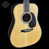 Acoustic guitar with a visible brand logo in the corner