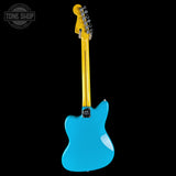 A turquoise blue electric guitar shown from the back against a solid black background, with a yellow neck and headstock. A Tone Shop watermark is visible in the top-left corner.