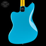 The back of a Fender electric guitar with a vibrant turquoise blue body and a yellow maple neck, shown against a solid black background.
