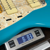 Used 2023 Fender American Pro II Jazzmaster Miami Blue on scale displaying weight.