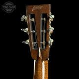 Close-up of a guitar headstock with 'Collings' branding on a black background.