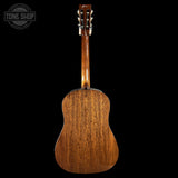 Back view of a wooden acoustic guitar with 'Tone Shop' logo in the corner.