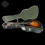 Guitar in an open hard-shell case with 'Tone Shop' logo.