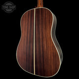 Wooden acoustic guitar back with 'Tone Shop' logo in the corner