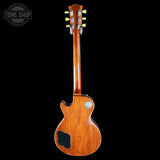 Back view of a wooden electric guitar on a black background with 'Tone Shop' logo.
